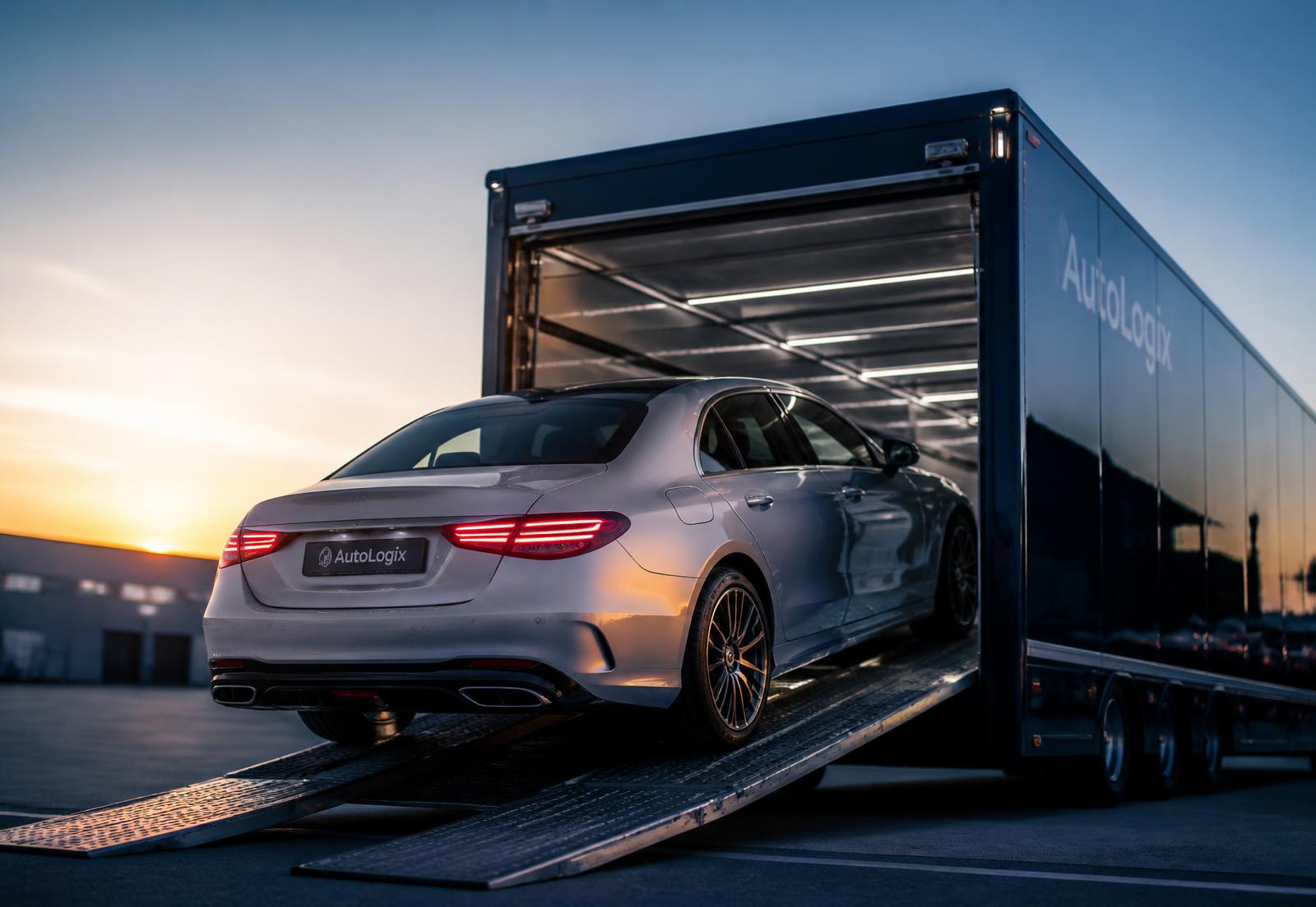 Luxury sedan being loaded onto an enclosed ShipX carrier